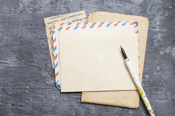 Sheet of vintage paper and fountain pen on grey background