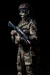 Special forces soldier in camouflage with rifle