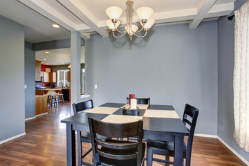 simplistic dinning room with gray walls.