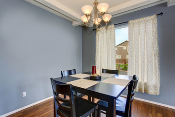 simplistic dinning room with gray walls.