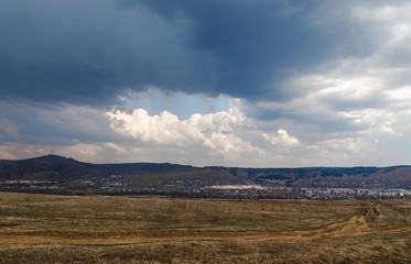 leaving road to city against clouds and round skylight