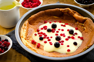 pudding with frozen berries and vanilla sauce