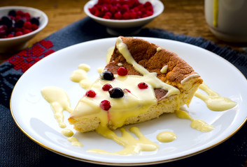 pudding with frozen berries and vanilla sauce