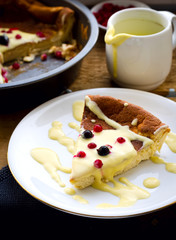 pudding with frozen berries and vanilla sauce