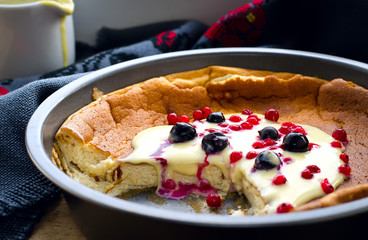 pudding with frozen berries and vanilla sauce