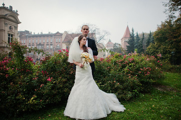 Young elegant and hearty wedding couple in love on streets of Kr