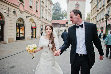 Young elegant and hearty wedding couple in love on streets of Kr