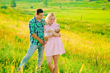 young family spending time together in green nature