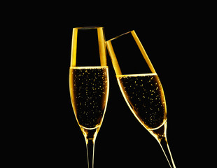 two champagne glasses on black background