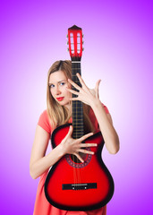 Female guitar player against the gradient 