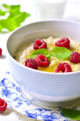 Oat porridge with raspberry and honey.