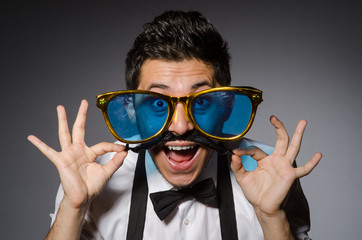 Young man with false moustache and large sunglasses isolated on