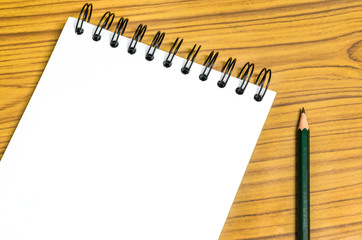 Blank paper and pencil on the wooden table