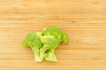 Green cabbage broccoli flower on wood board