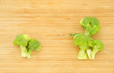 Green cabbage broccoli flower on wooden board