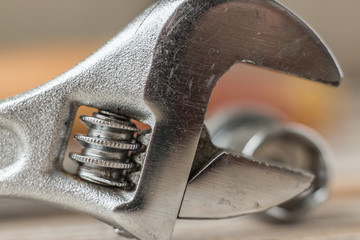 horizontal macro close up image of one solid steel hand wrench.