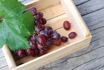 Red grapes on a wooden floor