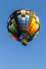 Brightly colored hot air balloon with a sky blue backgroun