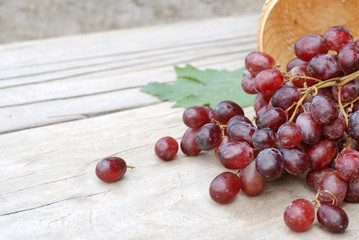 Red grapes on a wooden floor