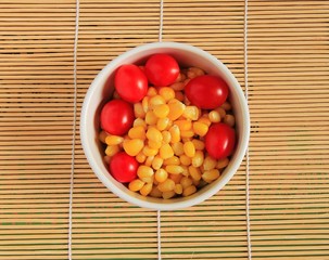 Ripe corn and tomatoes in bowl © pimonpim