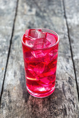 Red juice in a glass with ice