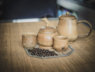 Vintage photo of coffee beans and Coffee cups set on wooden back
