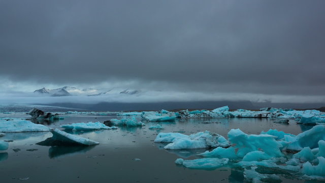 Time Lapse of blue icebergs floating in Jokulsarlon glacial lagoon, Iceland. Climate Change Global Warming Concept.