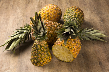 Some pineapples over a wooden table