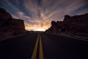 Empty Road leading towards the  rising moon