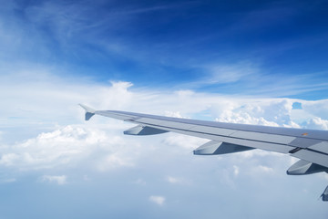 Fototapeta na wymiar airplane wing on the clouds sea