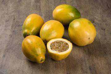 Close up of some passion fruits over a wooden surface seen from