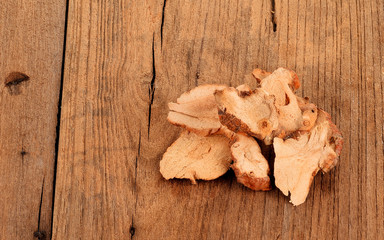 Dried galangal on wooden background