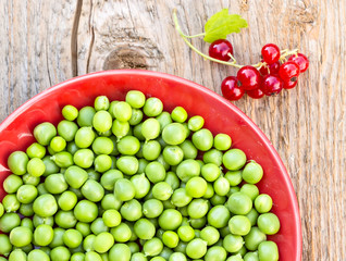 Green peas on the red plate