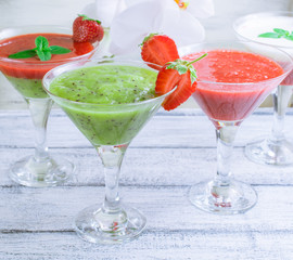 Fresh fruit and berry cocktail on shabby wooden boards