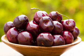 Close up of some cherries on a green and natural background