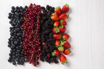 Some gooseberries, raspberries, strawberries and blueberries ove