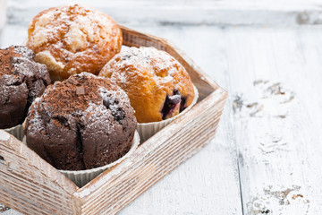 assortment of fresh delicious muffins on tray