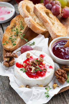 delicious appetizers - camembert with berry jam, toast and fruit