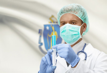 Doctor with syringe in hands and US states flags on background series - Massachusetts