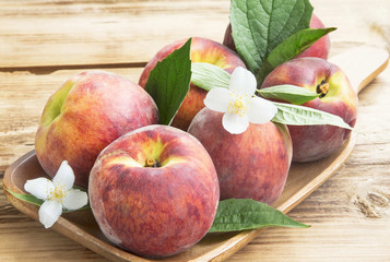 Fresh Peaches with Flowers and Leaves