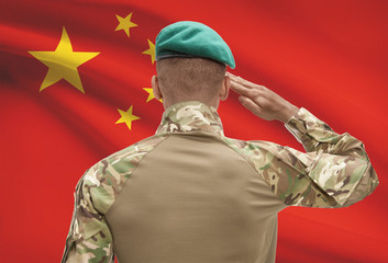 Obraz premium Dark-skinned soldier with flag on background - China