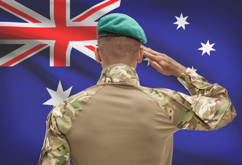 Fototapeta premium Dark-skinned soldier with flag on background - Australia