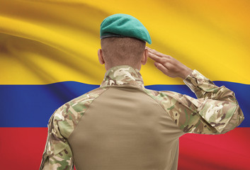 Dark-skinned soldier with flag on background - Colombia