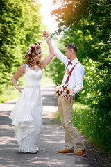 Fototapeta premium bride and groom walking on the road
