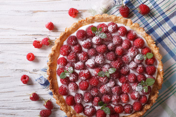 Fresh raspberry tart with cream cheese closeup. horizontal top view
