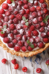 Homemade raspberry tart with cream close-up. Vertical top view
