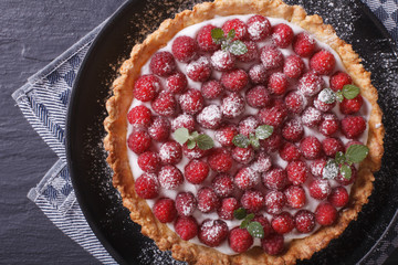 Gourmet raspberry tart with whipped cream close-up. Horizontal top view
