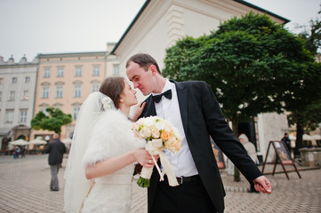 Young elegant and hearty wedding couple in love on streets of Kr