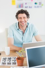  Cheerful casual businessman typing on laptop