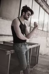 handsome man model dressed punk, hipster posing dramatic in grun